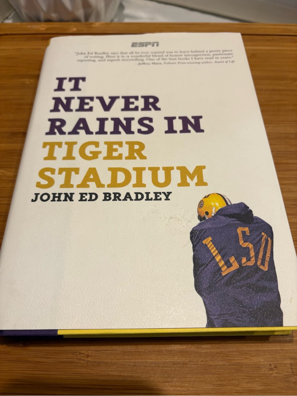 'It Never Rains in Tiger Stadium' by John Ed Bradley - White & Gold Cover